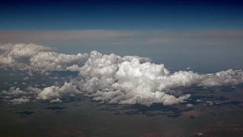 Cumulus clouds above Kazakhstan steppe seen through airplane window - Puffy Mass Stock Footage 339726411
