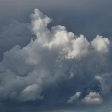 Cumulus clouds against a background of solid cloud cover 写真素材