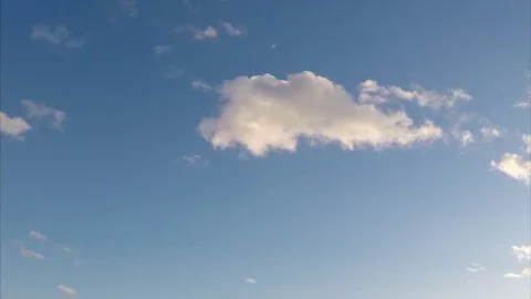 Cumulus clouds against blue sky timelapse Stock Footage 77283098