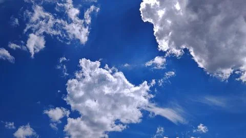 Cumulus Clouds Against Deep Blue Sky Stock Photos