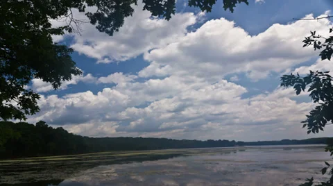 Cumulus clouds against light blue sky - 4K Ultra HD time lapse Video stock 35511736