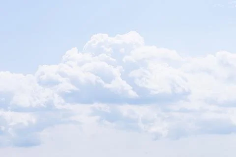 Cumulus clouds on a background of blue sky. The weather is expected to change Stock Photos