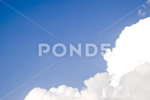 Cumulus clouds in the blue sky. Heavenly landscape. Photograph of the sky. Stock Photos