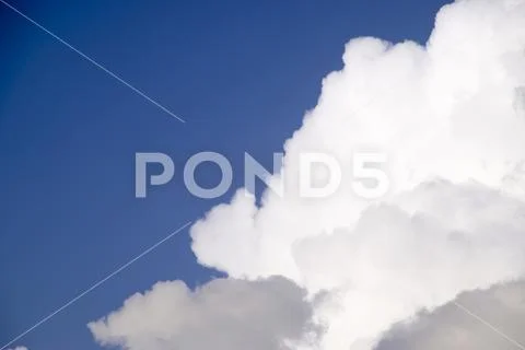Cumulus clouds in the blue sky. Heavenly landscape. Photograph of the sky. Stock Photos