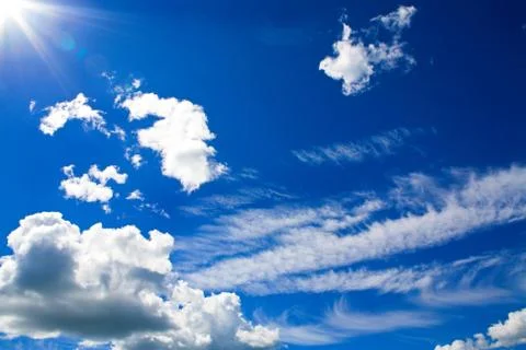 Cumulus clouds in blue sky Stock Photos