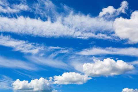 Cumulus clouds in blue sky Stock Photos