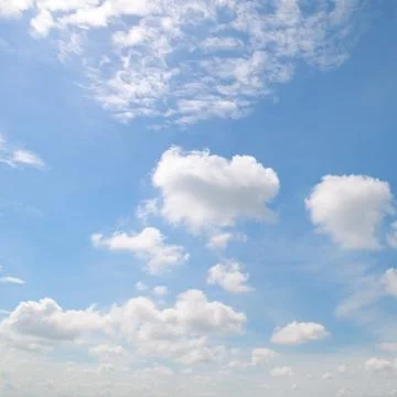 Cumulus clouds in the blue sky Stock Photos