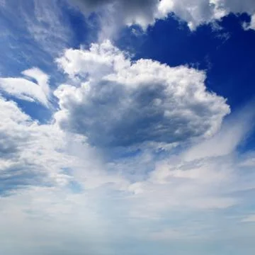 Cumulus clouds in blue sky Stock Photos