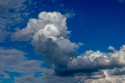 Cumulus clouds in a blue sky. Stock Photos