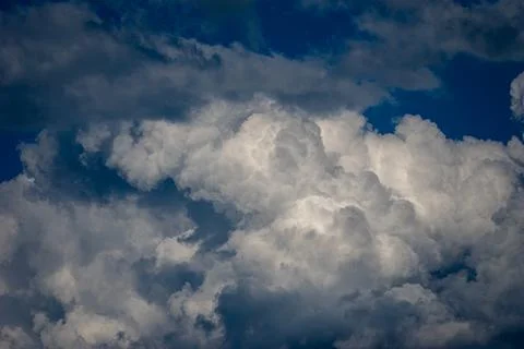 Cumulus clouds in a blue sky. Stock Photos