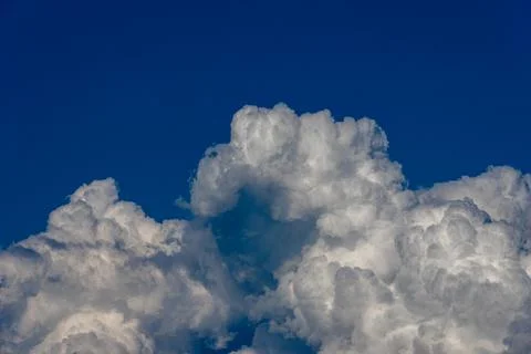 Cumulus clouds in a blue sky. Stock Photos
