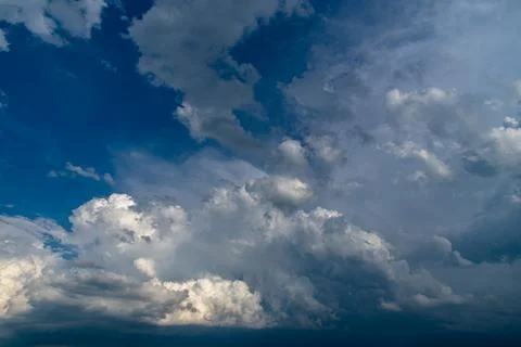 Cumulus clouds in a blue sky. Stock Photos