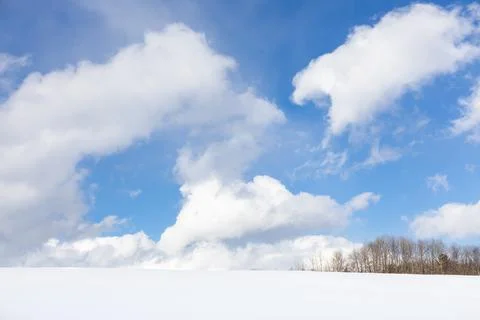 Cumulus clouds in bright blue sky Stock Photos