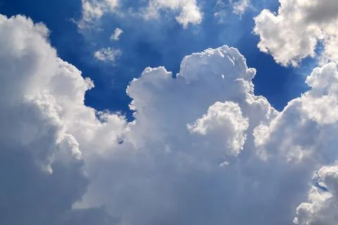 Cumulus Clouds in Bright Blue Sky Stock Photos