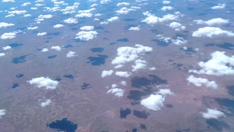 Cumulus clouds casting shadows over a deserted landscape. Stock Footage 278463373