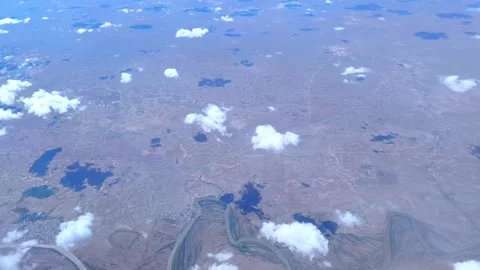 Cumulus clouds casting shadows over a deserted landscape. Video stock 278736398