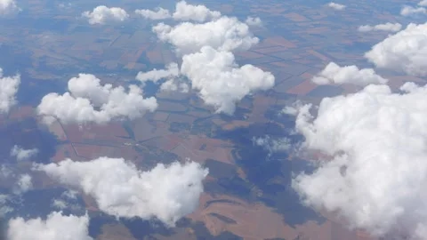 Cumulus clouds casting shadows over a varied landscape in 4k slow motion 60fp Stock Footage 284219104