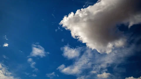 Cumulus Clouds Dance Across Intense Blue Sky Stock Footage 285057525