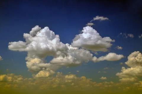 Cumulus Clouds in a Dark Blue Sky Stock Photos
