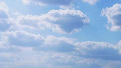 Cumulus clouds drifting across a clear blue sky Time Lapse, Timelapse Nature Stock Footage 329315011