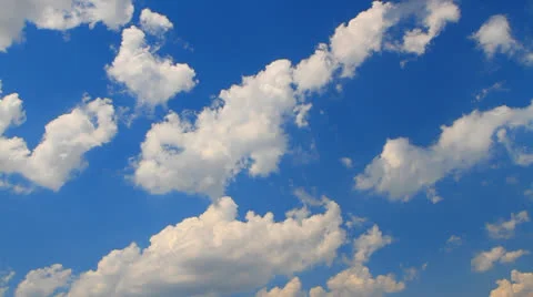 Cumulus clouds, floating on a blue sky in a strong wind Stock Footage