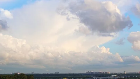Cumulus clouds fly quickly over the urban industrial zone Stock Footage 331811771