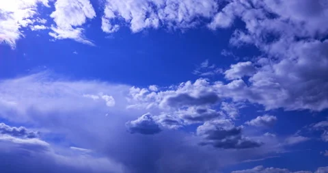 Cumulus clouds flying against a blue sky Stock Footage 194099143