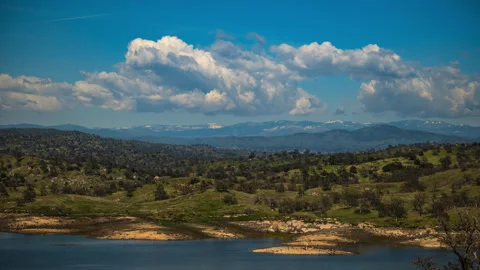 Cumulus Clouds form over Reservoir in California's Sierra Nevada Stock Footage 282445786