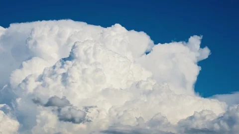 Cumulus clouds forming on a blue summer day Video stock 71312358