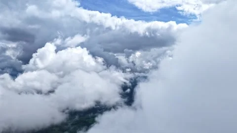 Cumulus clouds high altitude airplane window view in the sky blue sky above Stock Footage 314479148