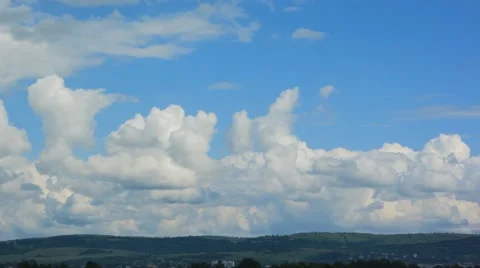 Cumulus clouds move against the blue sky. Stock Footage 62513879
