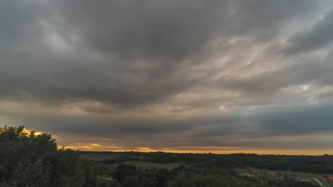 Cumulus clouds moving fast in the sunset sky Video stock 158747483