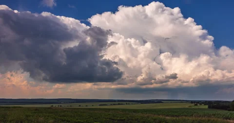 Cumulus clouds over a green field Stock Footage 293311758
