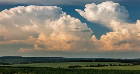 Cumulus clouds over a green field Stock Footage 293314691
