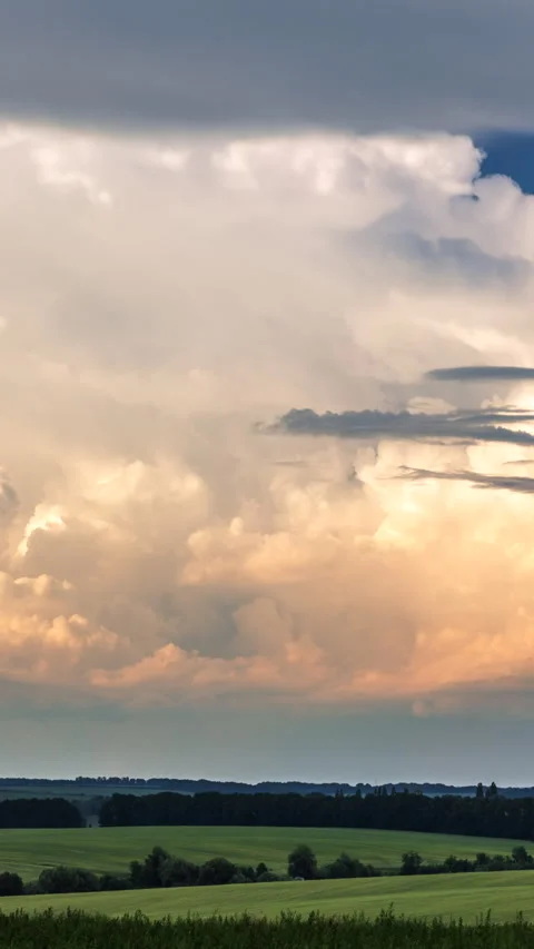 Cumulus clouds over a green field Video stock 293315087