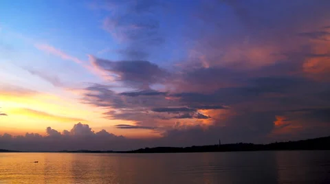 Cumulus clouds over a harbor on evening sun Stock Footage 2257514