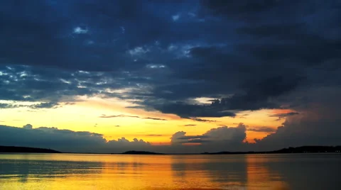 Cumulus clouds over a harbor on evening sun Stock Footage
