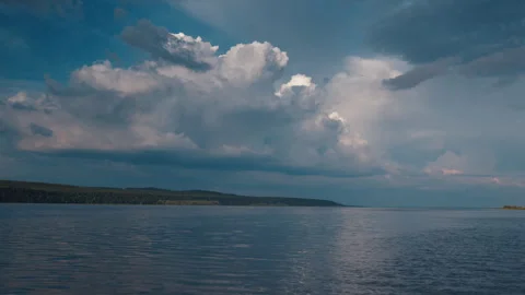 Cumulus clouds over the river during calm summer day Stock Footage 338039258