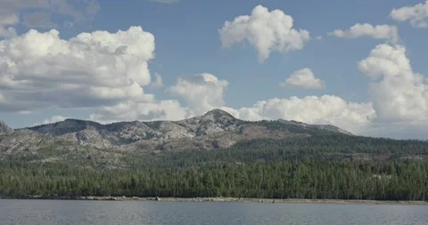 Cumulus clouds passing over mountain peaks and pine forest at Loon Lake Stock-Footage 347636432