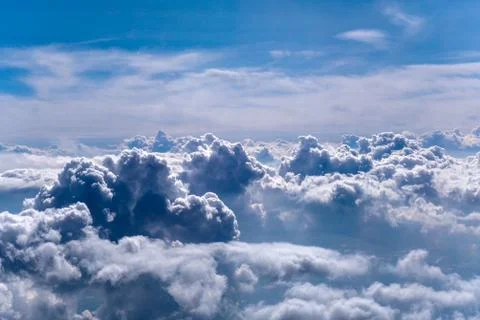 Cumulus clouds by the plane Stock Photos