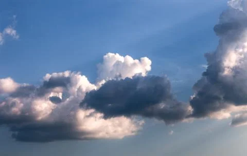 Cumulus clouds with rays of sun Stock Photos