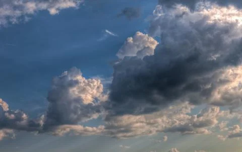 Cumulus clouds with rays of sun Stock Photos