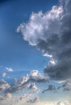 Cumulus clouds with rays of sun Stock Photos