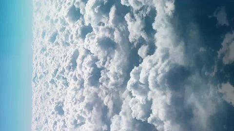 Cumulus Clouds Scattered Across Blue Sky with Bird's-eye View Seen Through .. Stock Footage 239380098