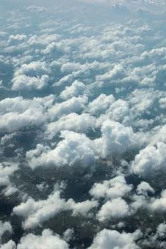 Cumulus clouds seen from above. Cloudscape at high altitude Stock Photos