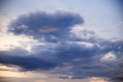 Cumulus clouds in the sky at sunset. Dramatic sky. Stock Photos
