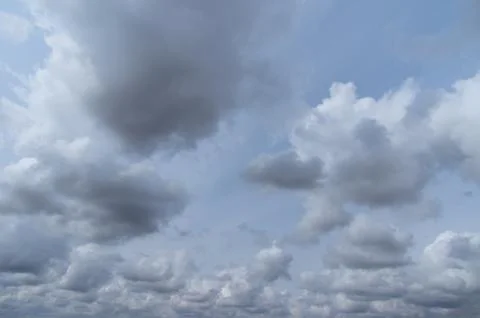 Cumulus clouds soaring high in the blue sky Stock Photos
