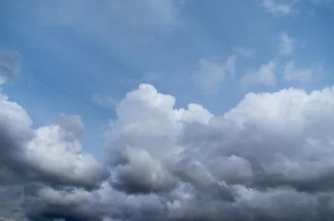 Cumulus clouds soaring high in the blue sky Stock Photos