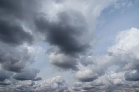Cumulus clouds soaring high in the blue sky Stock Photos