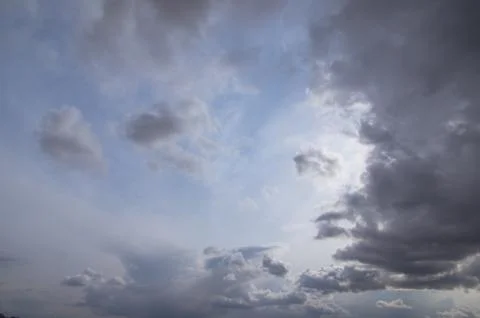 Cumulus clouds soaring high in the blue sky Stock Photos